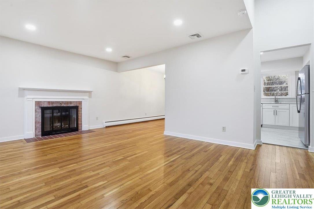 3120 Hilly Road Bethlehem, PA 18017 - Photo 3 of 37 a view of an empty room with wooden floor fireplace and a window