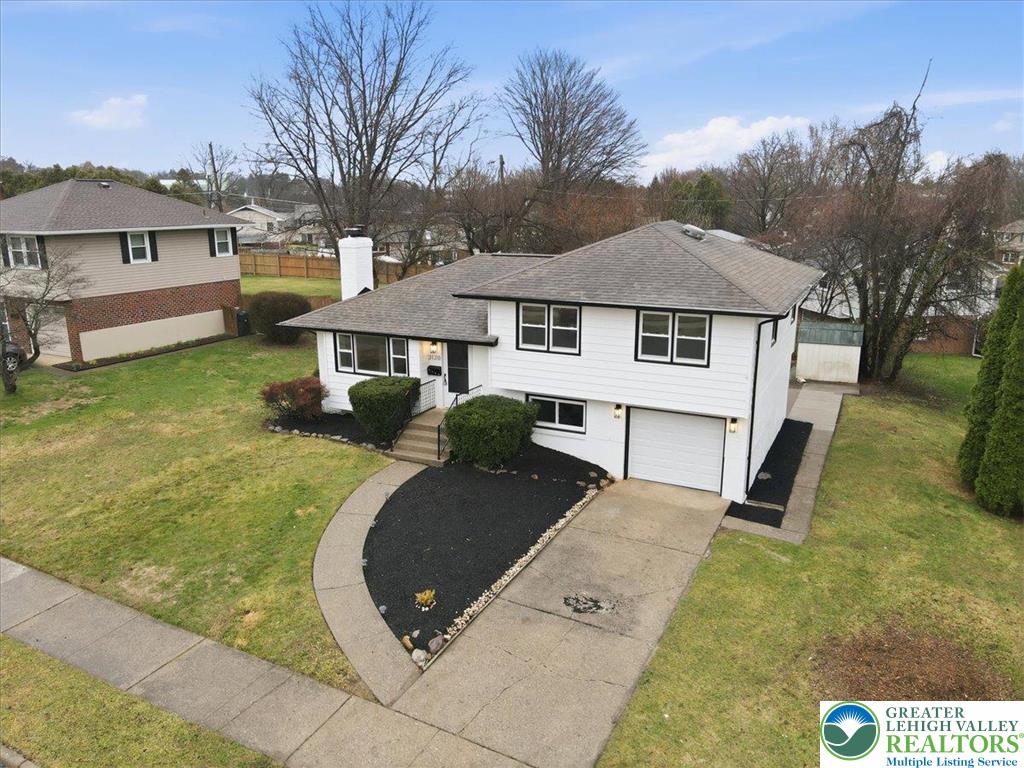 3120 Hilly Road Bethlehem, PA 18017 - Photo 31 of 37 a view of a white house with a yard and table and chairs under an umbrella
