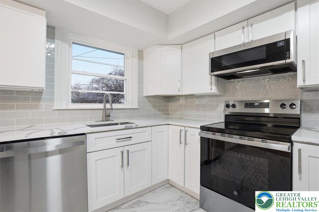 3120 Hilly Road Bethlehem, PA 18017 - Photo 8 of 37 a kitchen with stainless steel appliances a stove sink and microwave