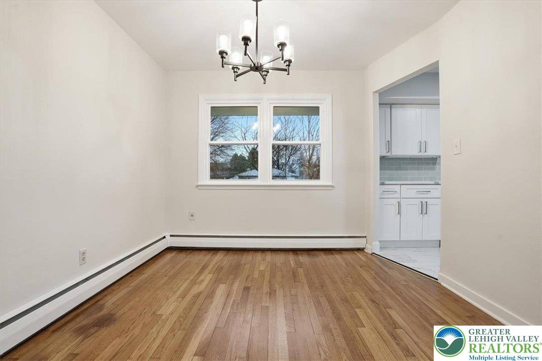 3120 Hilly Road Bethlehem, PA 18017 - Photo 10 of 37 an empty room with wooden floor cabinet and windows