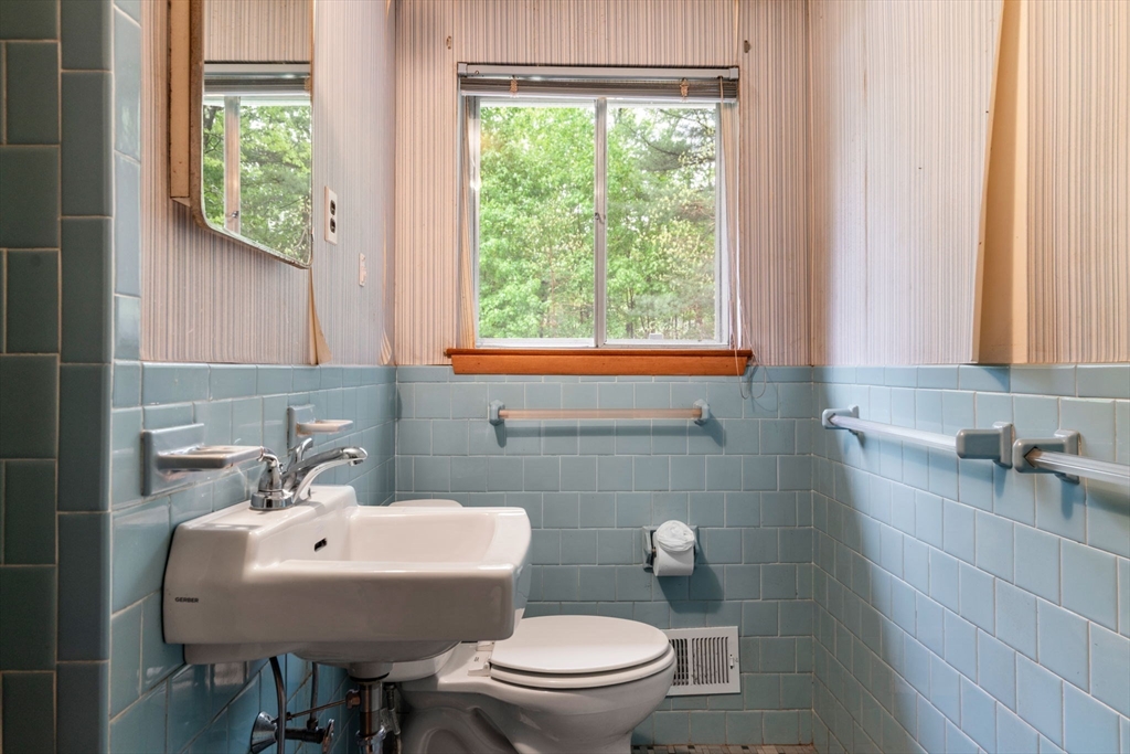 32 Lyman Road Framingham, MA 01701 - Photo 14 of 20 a bathroom with a sink a toilet and a mirror
