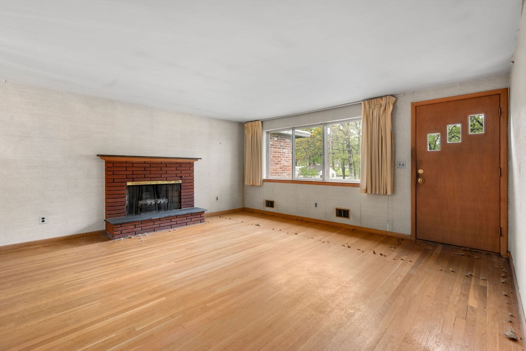 32 Lyman Road Framingham, MA 01701 - Photo 3 of 20 an empty room with windows and fireplace