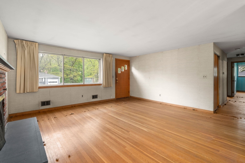 32 Lyman Road Framingham, MA 01701 - Photo 4 of 20 an empty room with wooden floor and windows
