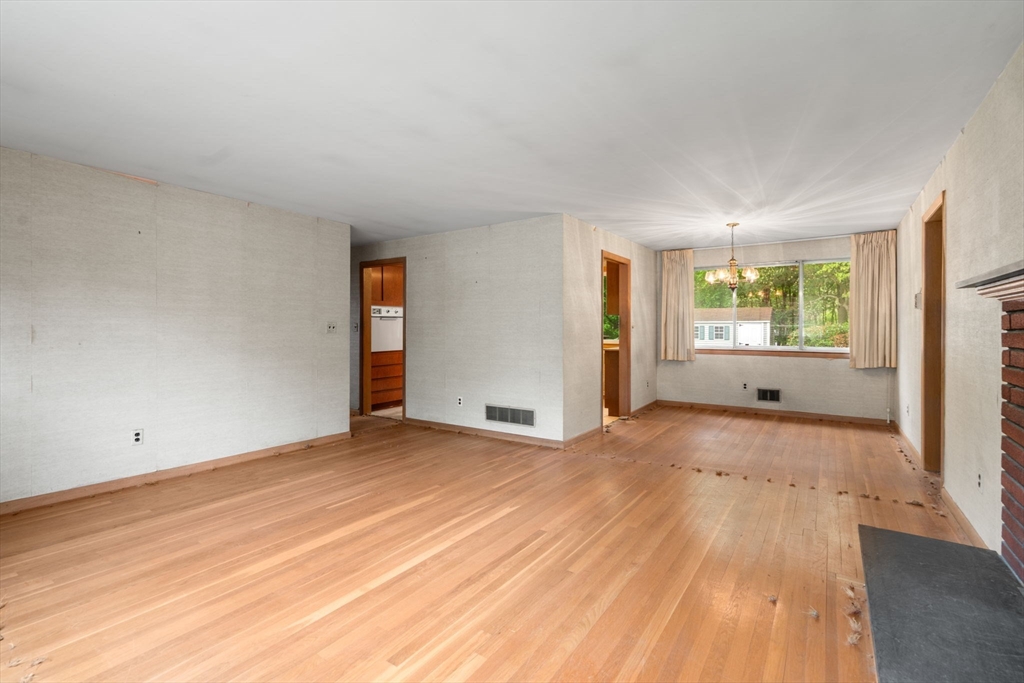 32 Lyman Road Framingham, MA 01701 - Photo 6 of 20 a view of an empty room with wooden floor and a window