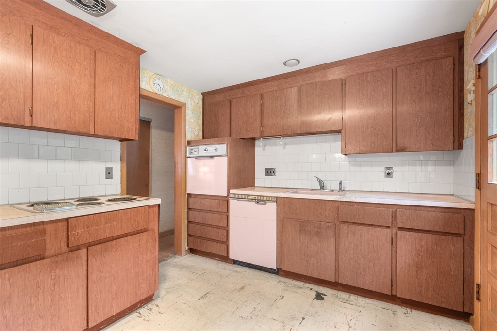 32 Lyman Road Framingham, MA 01701 - Photo 7 of 20 a kitchen with a sink stove and cabinets