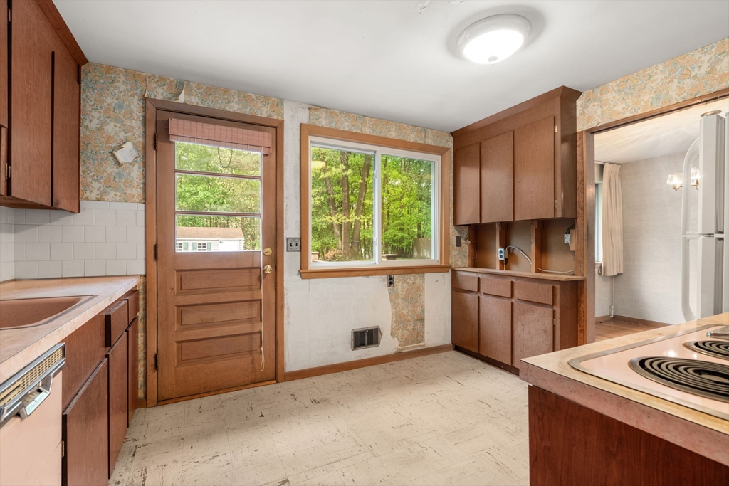 32 Lyman Road Framingham, MA 01701 - Photo 8 of 20 a kitchen with a stove a sink and a refrigerator