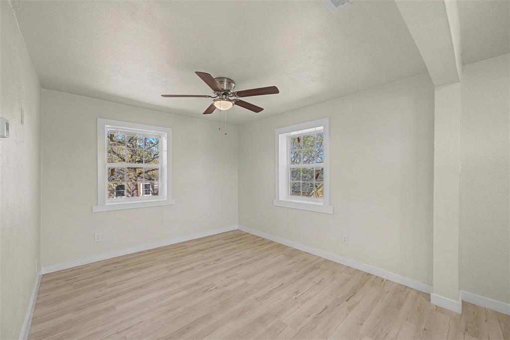 9021 White Settlement Road, Unit B White Settlement, TX 76108 - Photo 10 of 19 Bright interior room featuring light wood-finish flooring, white walls, and a ceiling fan with integrated lighting