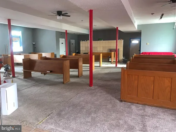 a view of a room with wooden floor