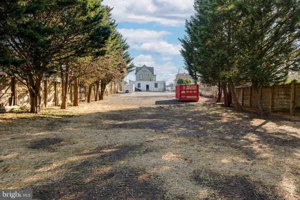 a view of a field with trees in front of it