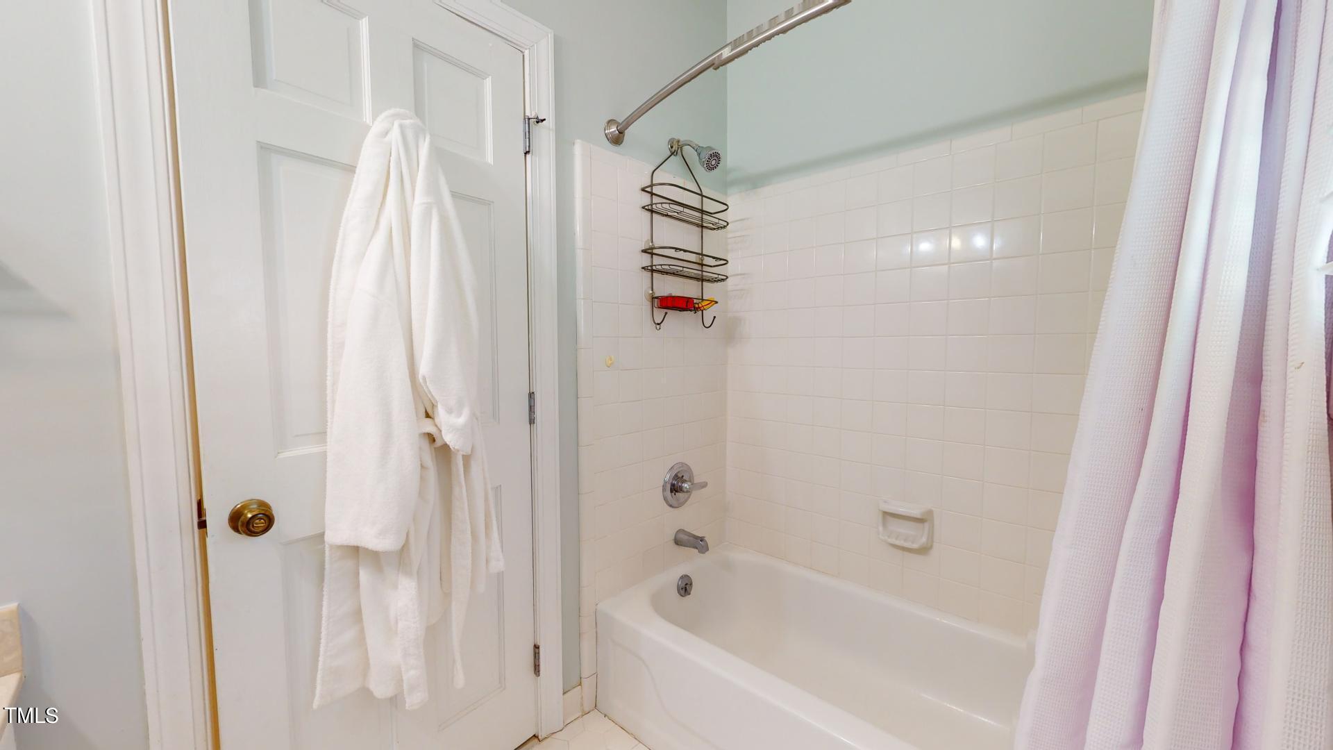 1833 Falls Church Road Raleigh, NC 27609 - Photo 25 of 84 a bathroom with a shower and a bath tub