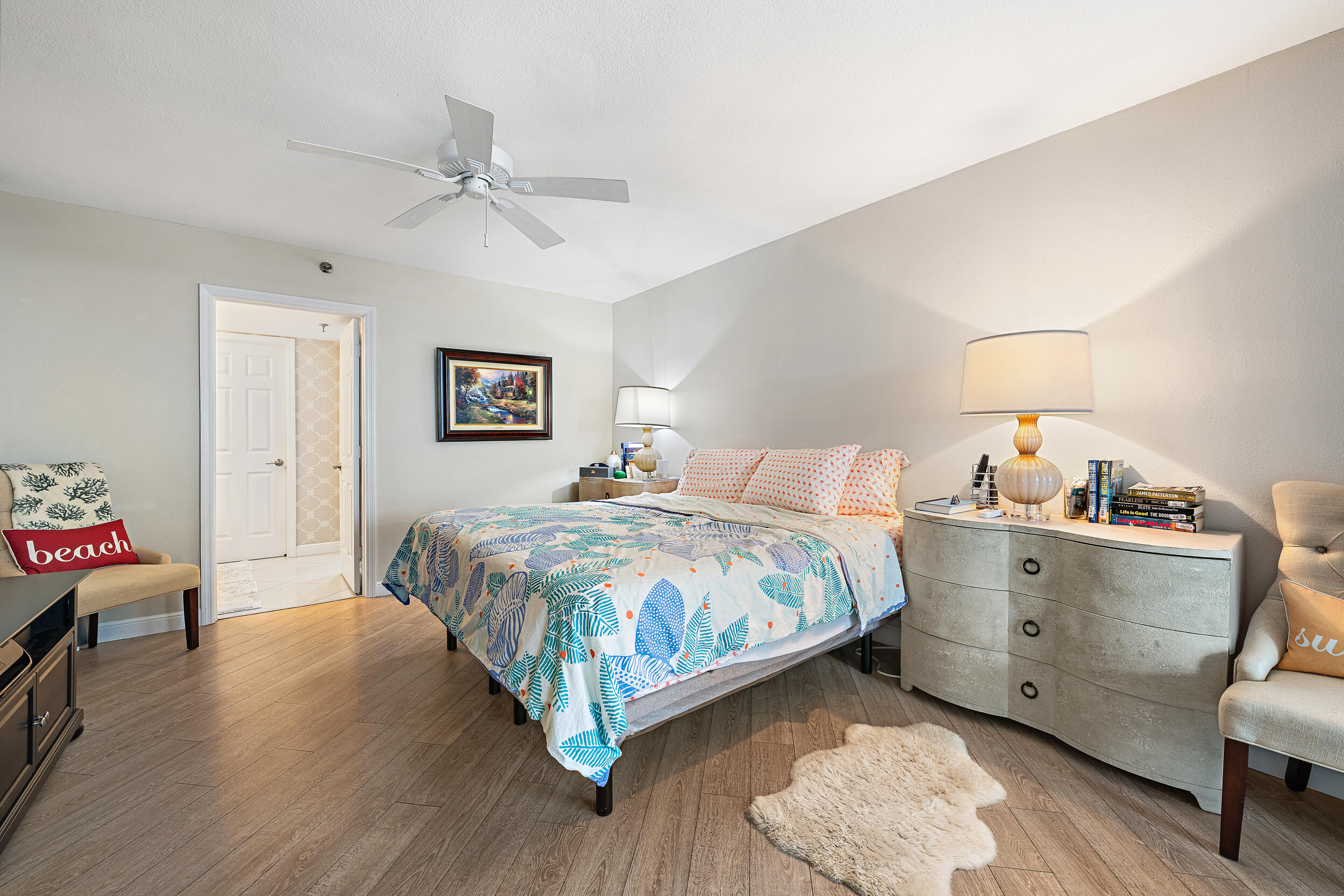 176 Helios Drive, Unit 603 Jupiter, FL 33477 - Photo 11 of 28 a bedroom with a bed and a chandelier
