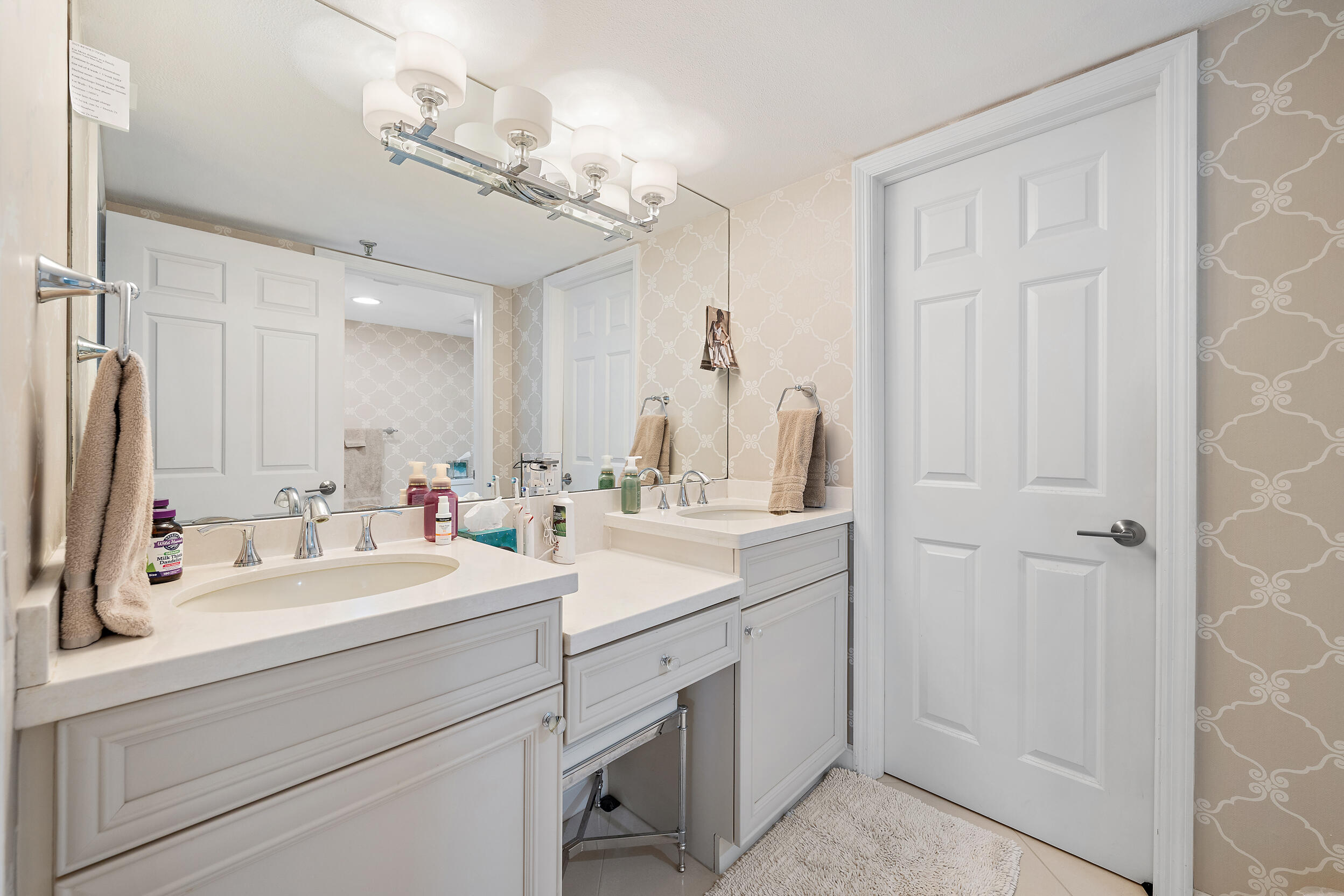 176 Helios Drive, Unit 603 Jupiter, FL 33477 - Photo 12 of 28 a bathroom with a double vanity sink mirror and
