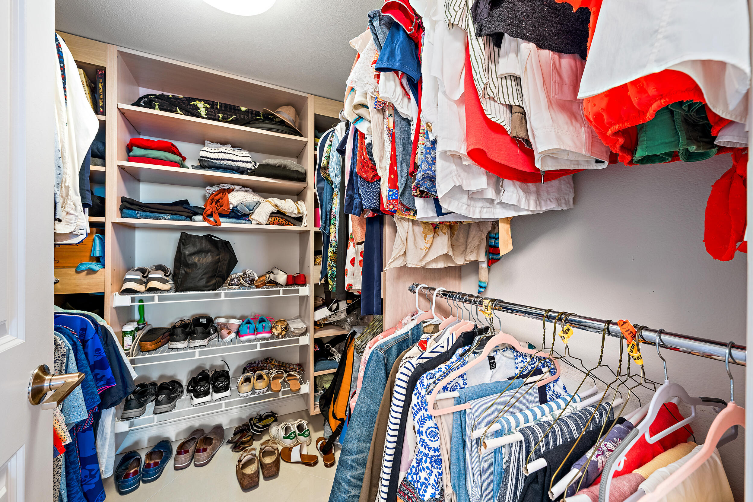 176 Helios Drive, Unit 603 Jupiter, FL 33477 - Photo 14 of 28 a view of walk in closet with clothes and shoes