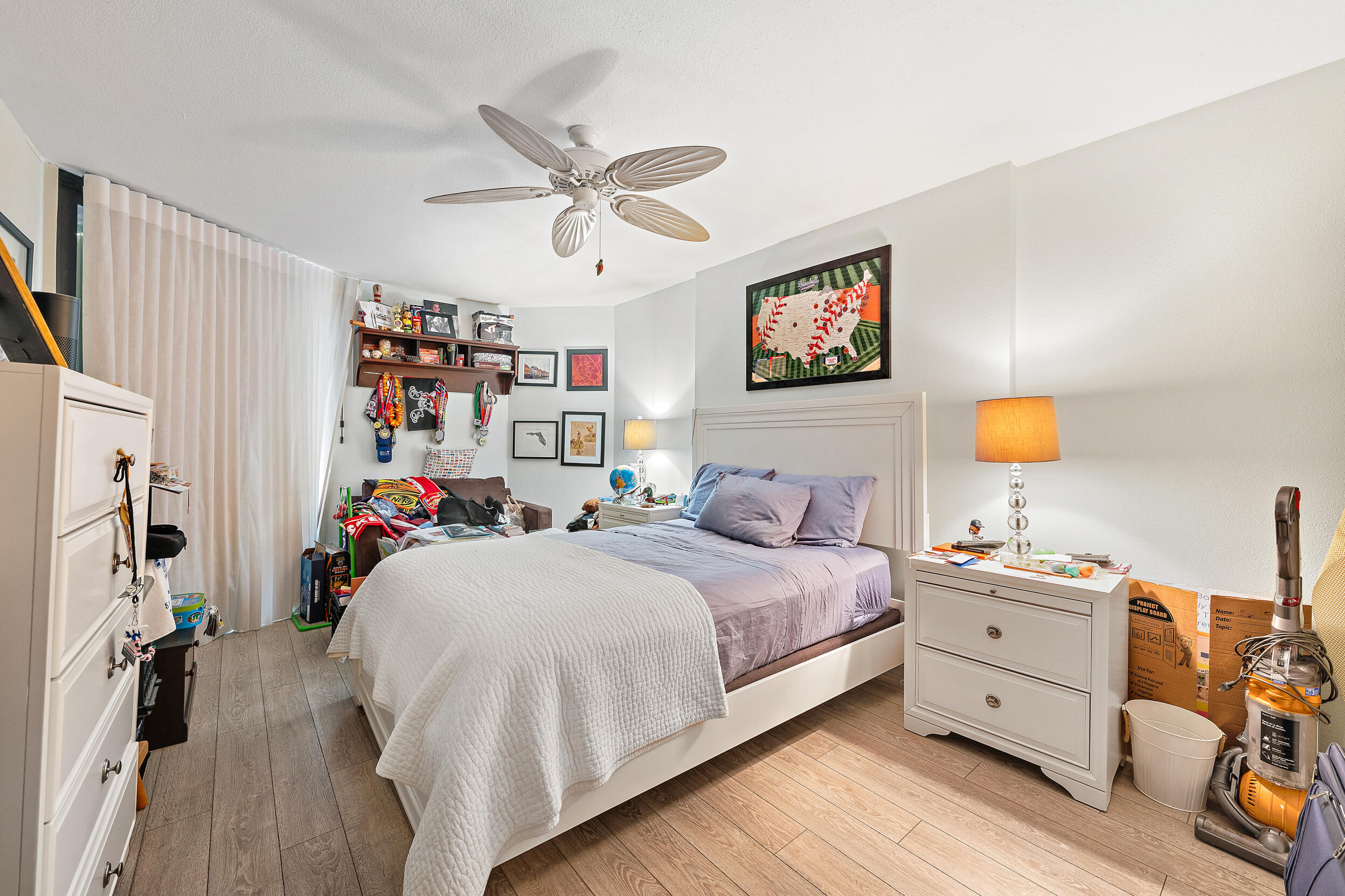 176 Helios Drive, Unit 603 Jupiter, FL 33477 - Photo 15 of 28 a bedroom with a bed and a chandelier