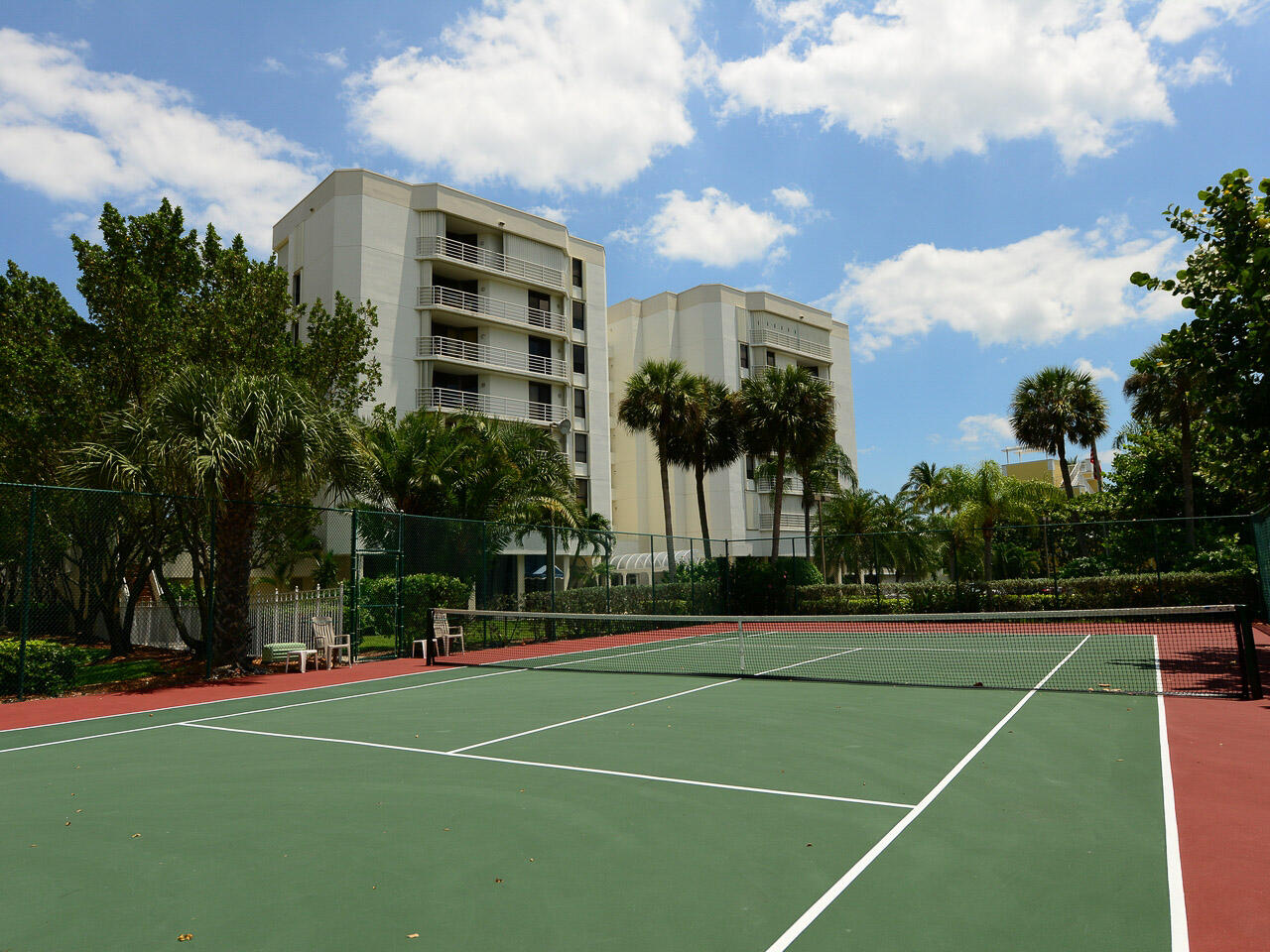 176 Helios Drive, Unit 603 Jupiter, FL 33477 - Photo 22 of 28 a view of a tennis ground with large trees