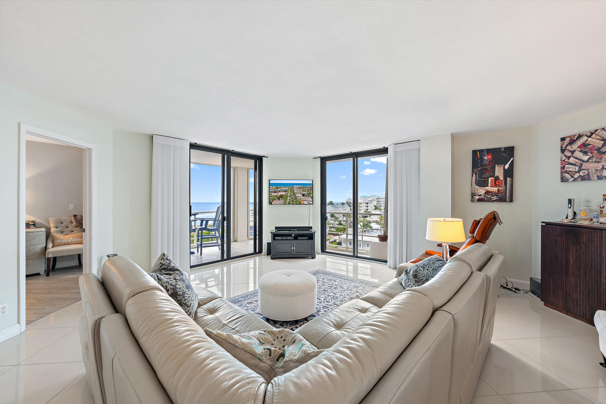 176 Helios Drive, Unit 603 Jupiter, FL 33477 - Photo 3 of 28 a living room with furniture and large windows