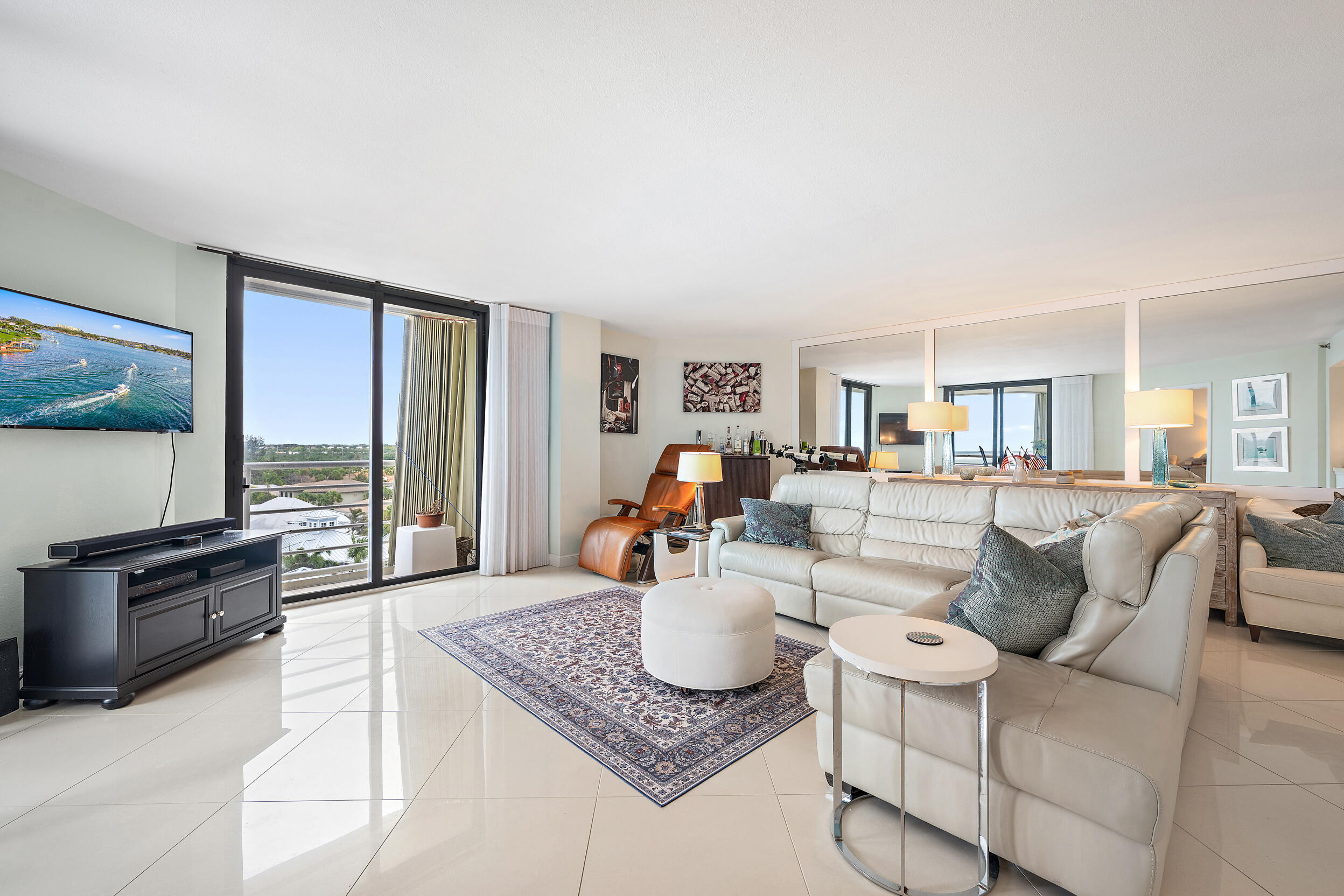 176 Helios Drive, Unit 603 Jupiter, FL 33477 - Photo 4 of 28 a living room with furniture and a flat screen tv