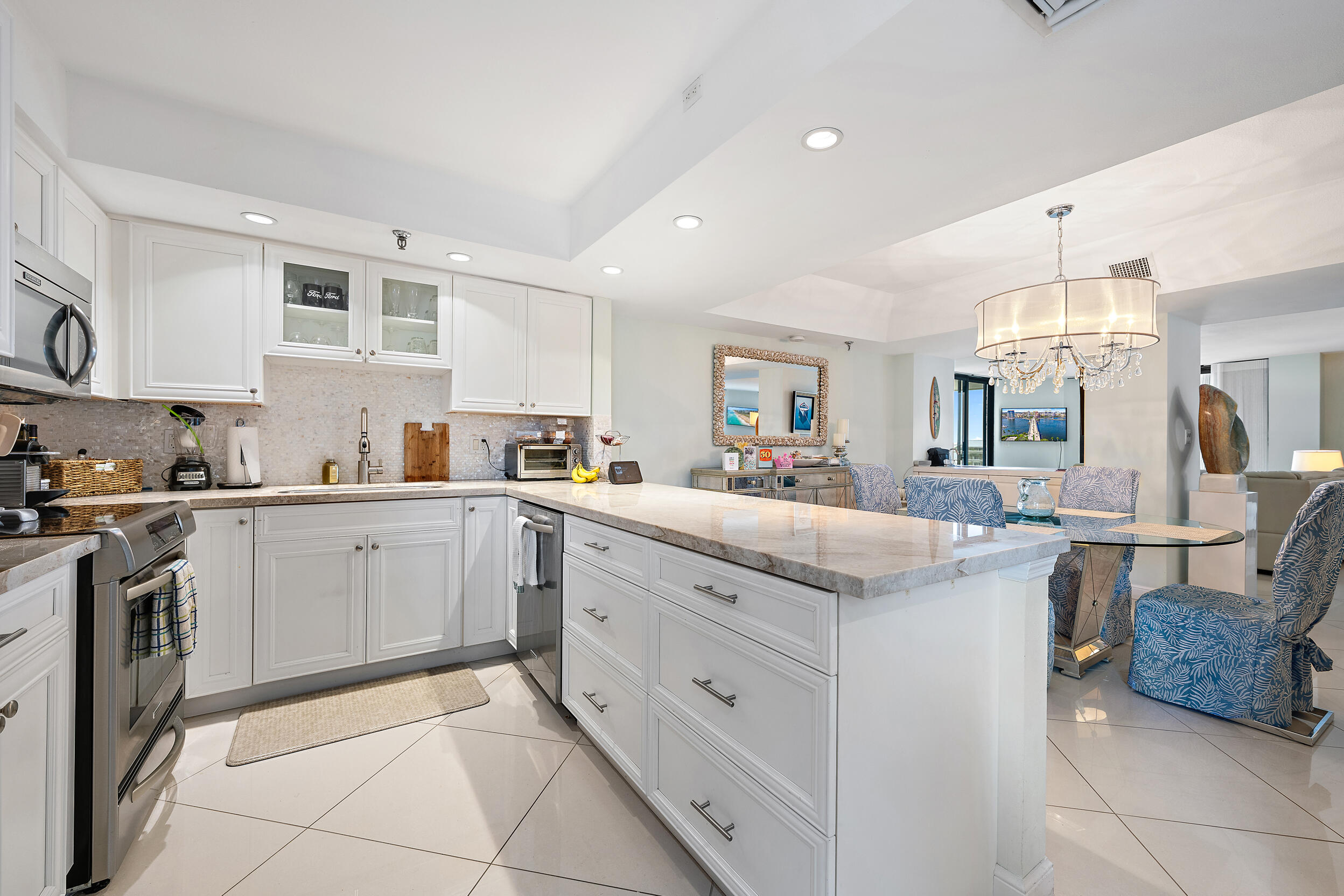 176 Helios Drive, Unit 603 Jupiter, FL 33477 - Photo 7 of 28 a kitchen with cabinets and chairs