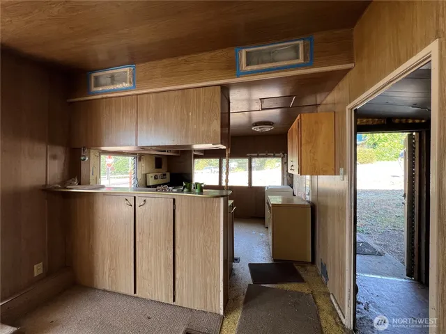 a kitchen with a refrigerator and a stove