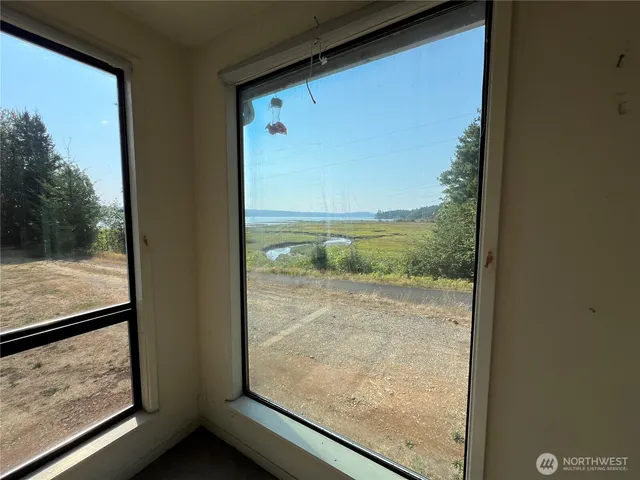 a view of a room with wooden floor and a window