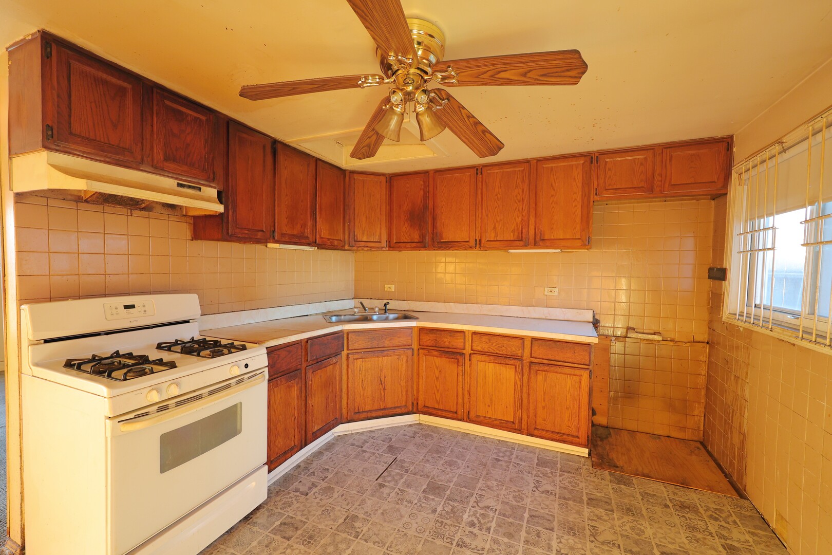 3210 Mc Breen Avenue Robbins, IL 60472 - Photo 8 of 21 a kitchen with stainless steel appliances a stove a sink and a refrigerator
