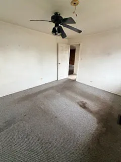 a view of empty room with ceiling fan