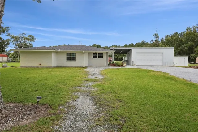 a view of a house with a yard and a garden