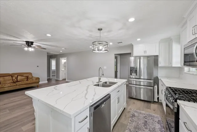 a kitchen with a sink stove and refrigerator