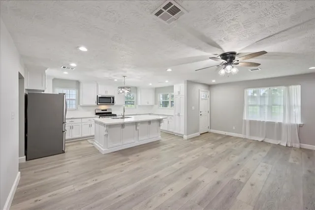 a view of kitchen with wooden floor and window