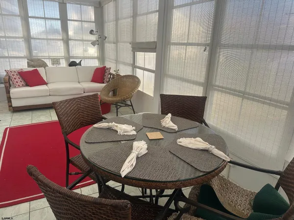 a balcony with table and chairs