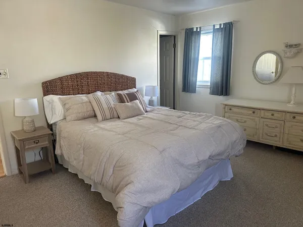 a bedroom with bed and wooden floor