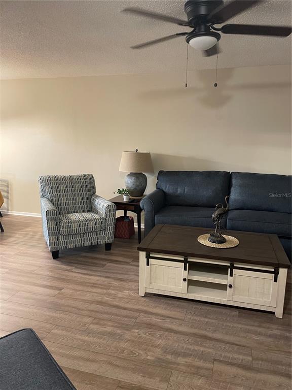 14531 Walsingham Road, Unit 203 Largo, FL 33774 - Photo 12 of 24 a living room with furniture and a wooden floor