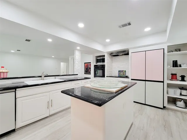 a view of a hallway with wooden floor and stairs