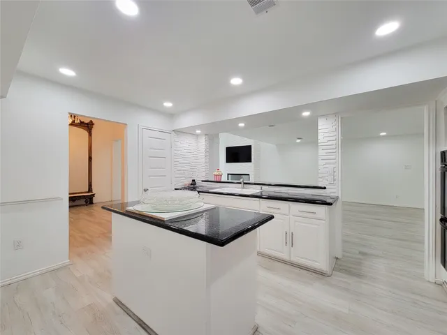 a kitchen with stainless steel appliances granite countertop a sink and a refrigerator