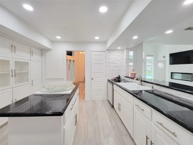 a kitchen with stainless steel appliances granite countertop a sink and a stove