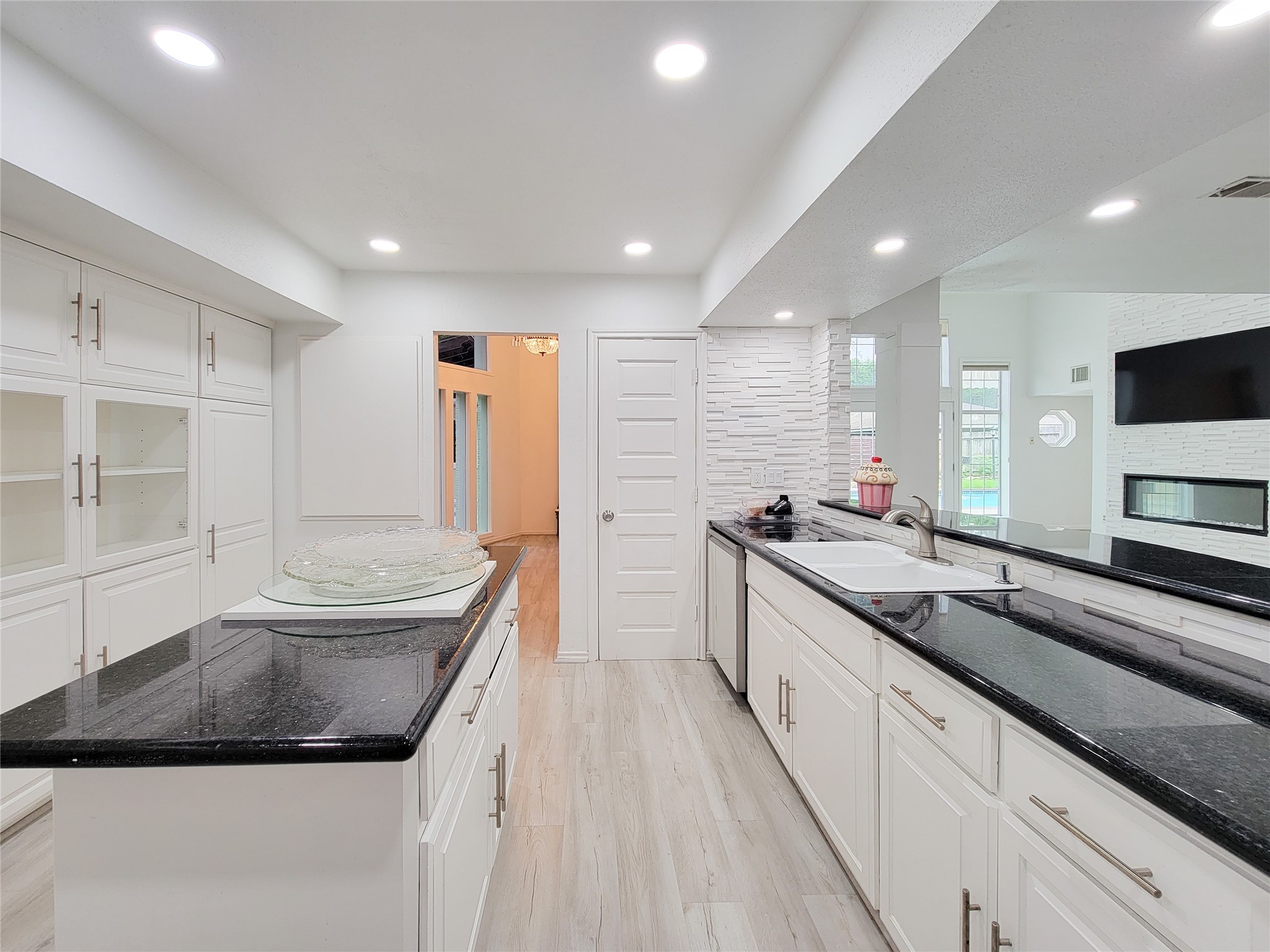 5654 Cheena Drive Houston, TX 77096 - Photo 13 of 50 a large kitchen with kitchen island a large counter top space a sink and stainless steel appliances