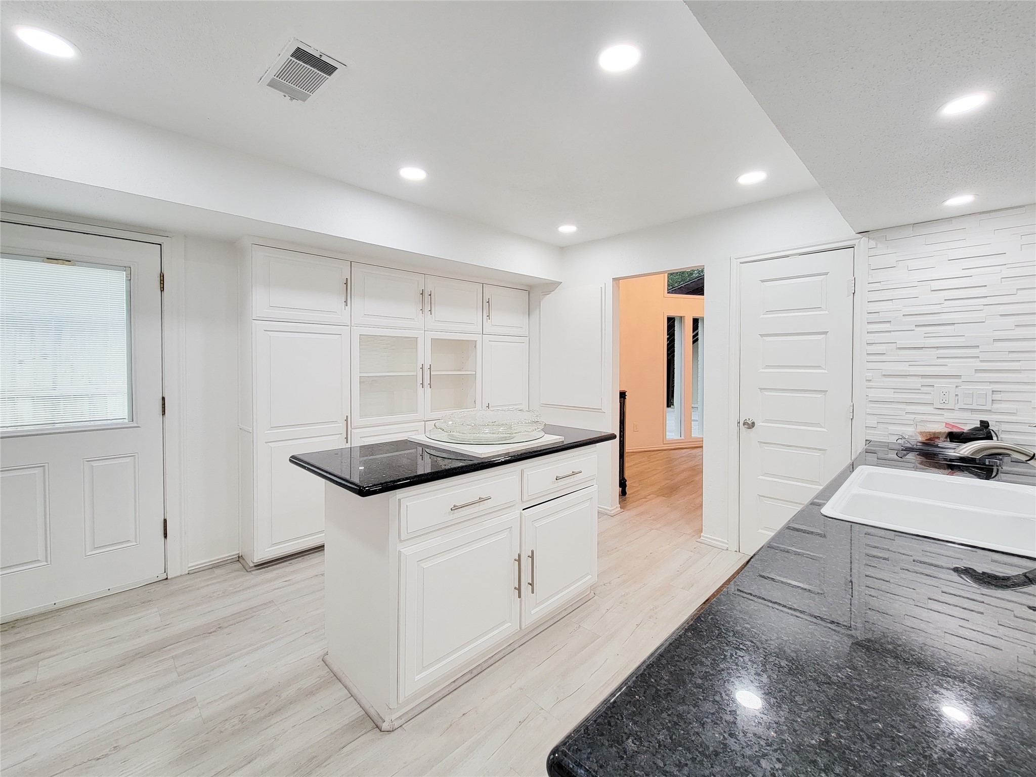 5654 Cheena Drive Houston, TX 77096 - Photo 14 of 50 a kitchen with granite countertop a sink and a stove top oven