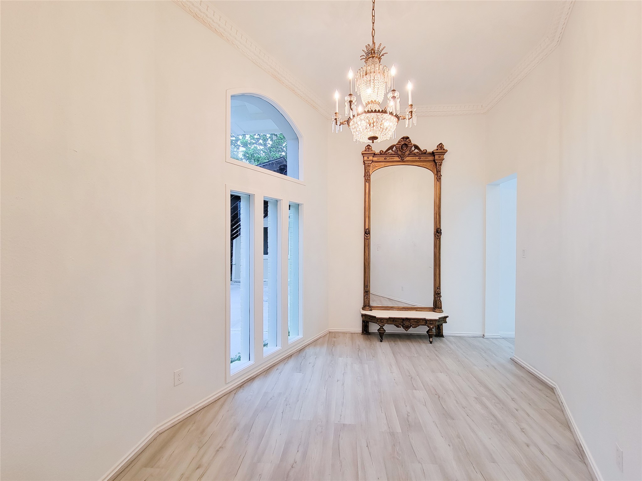 5654 Cheena Drive Houston, TX 77096 - Photo 17 of 50 a view of a room with wooden floor staircase and a chandelier