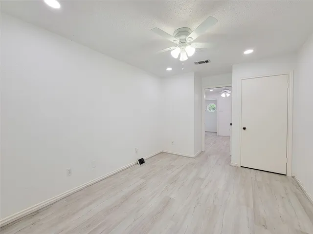 a view of a room with wooden floor staircase and a chandelier