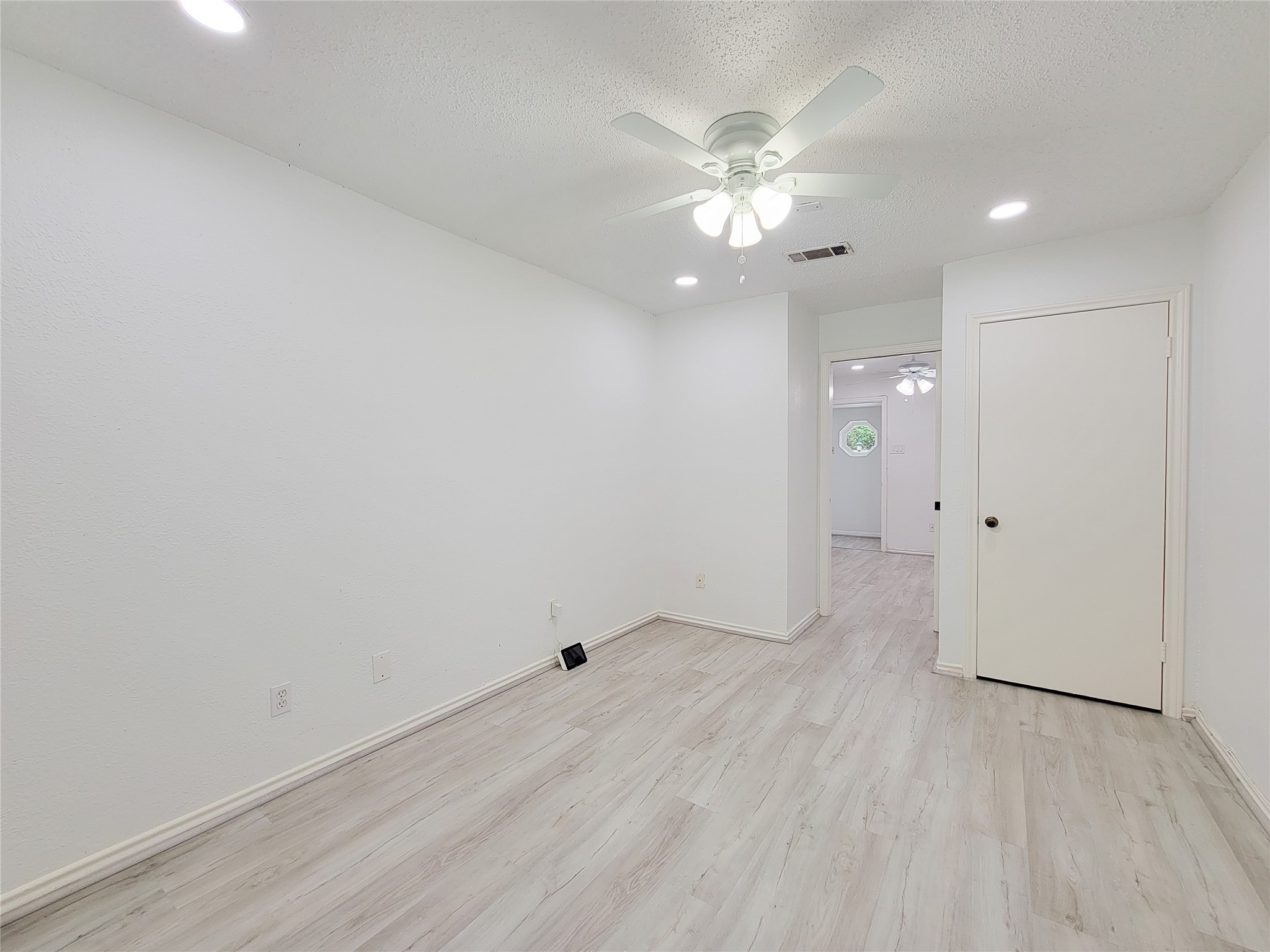 5654 Cheena Drive Houston, TX 77096 - Photo 18 of 50 an empty room with wooden floor and ceiling fan