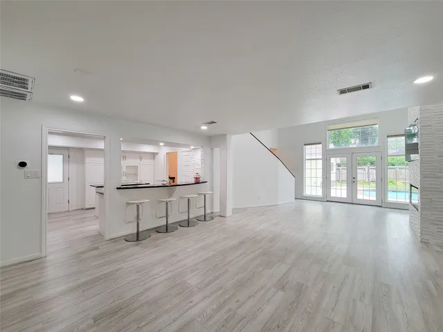 a view of empty room with wooden floor and window
