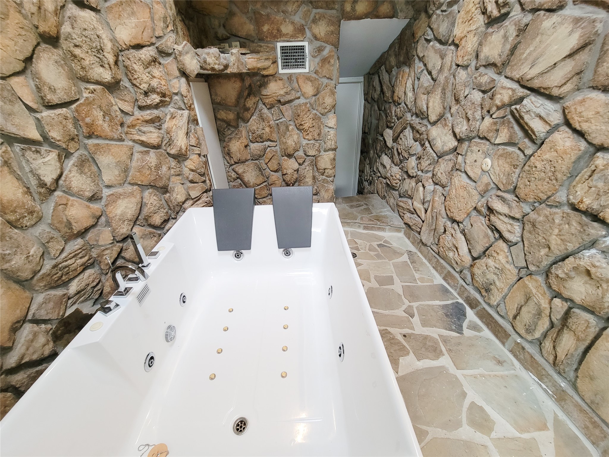 5654 Cheena Drive Houston, TX 77096 - Photo 26 of 50 a white bath tub sitting in a bathroom