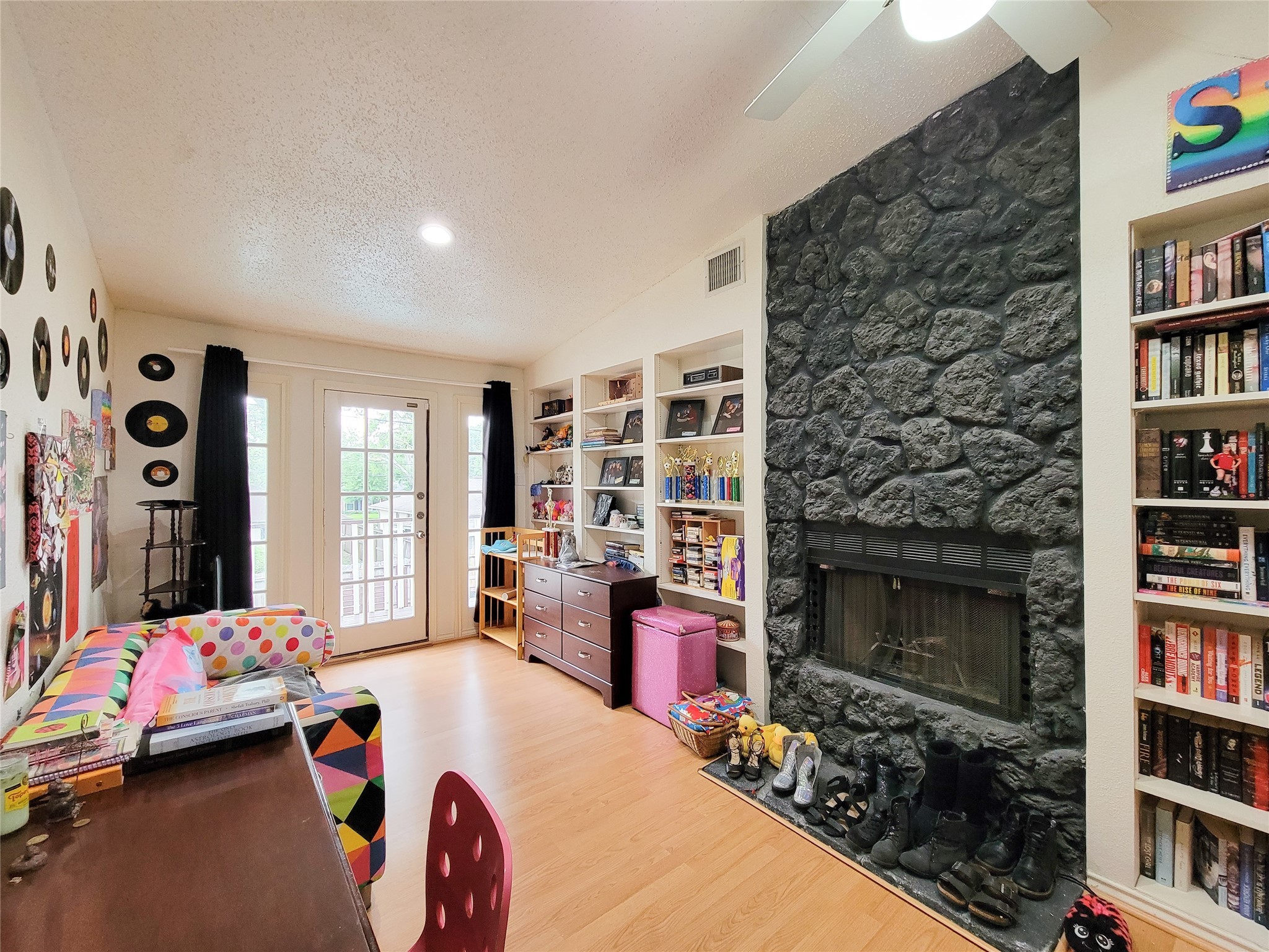 5654 Cheena Drive Houston, TX 77096 - Photo 33 of 50 a bedroom with furniture and a book shelf