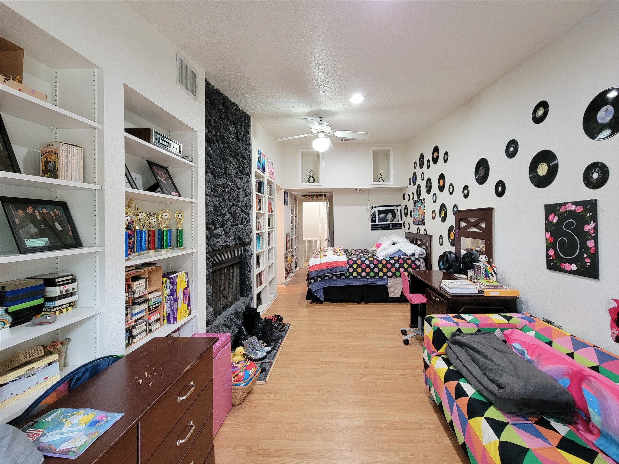 5654 Cheena Drive Houston, TX 77096 - Photo 34 of 50 a bedroom with furniture and a book shelf