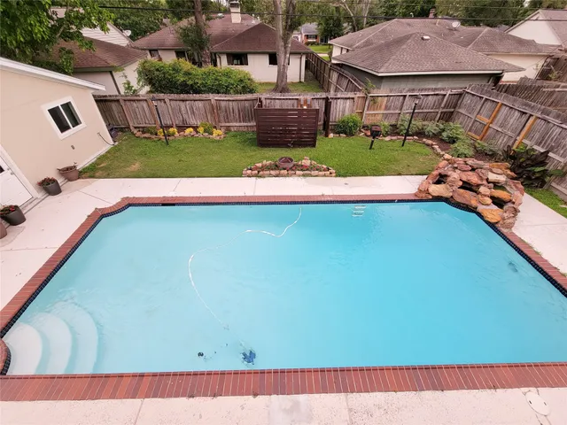a view of house with backyard outdoor seating and green space