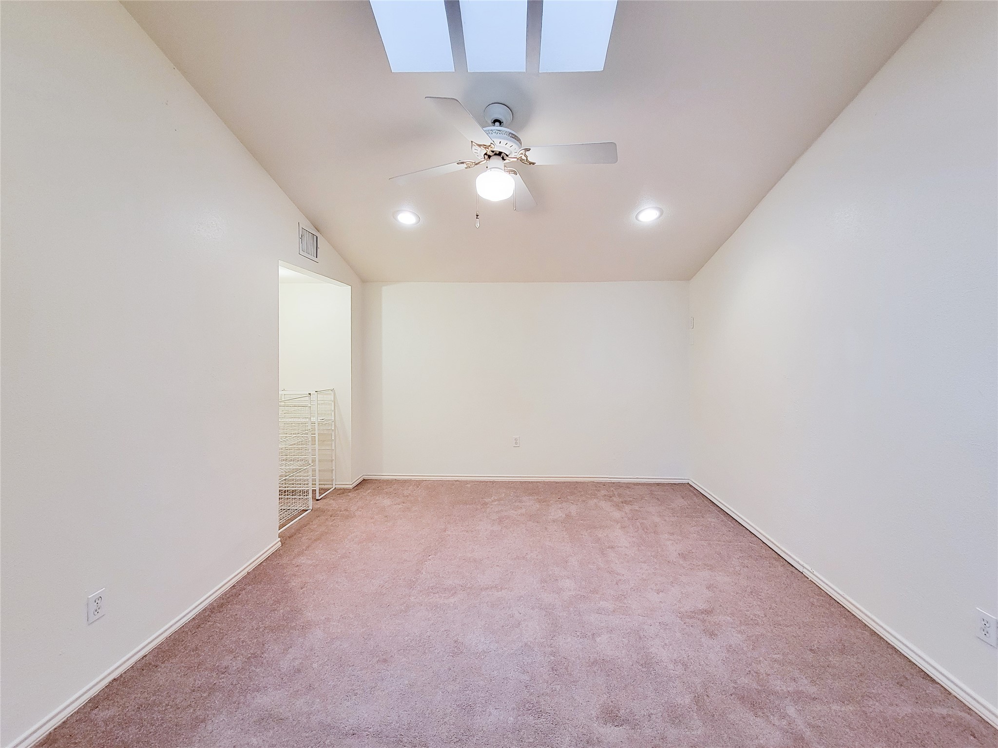 5654 Cheena Drive Houston, TX 77096 - Photo 39 of 50 an empty room with a ceiling fan and a window