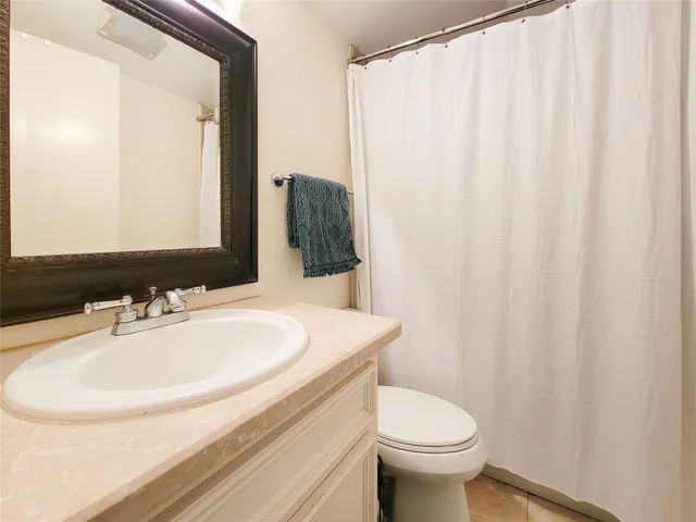 an empty room with a ceiling fan and a window