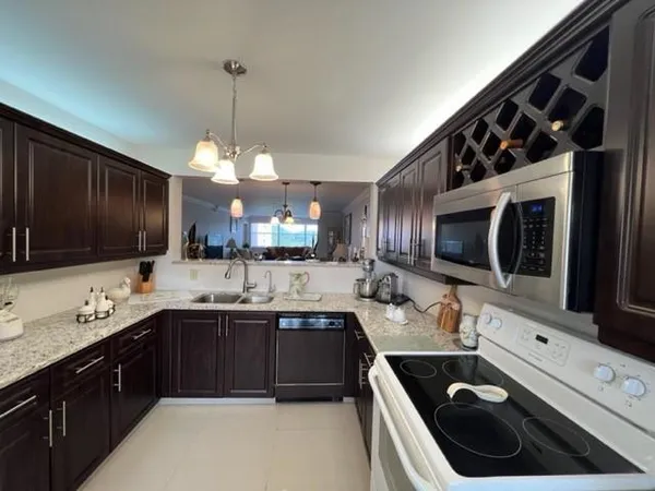 a kitchen with a sink stove and microwave