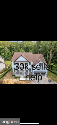 a front view of a house with a yard garage and outdoor seating