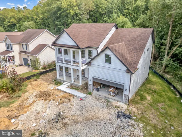 an aerial view of a house with a yard and garden